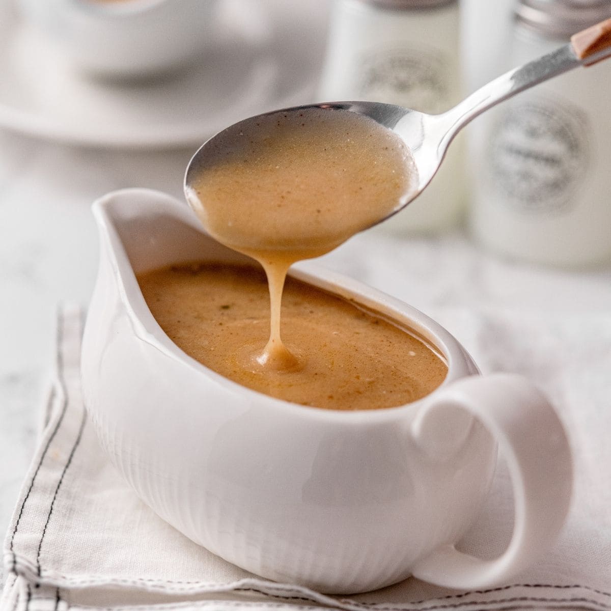Smooth turkey gravy served warm in a gravy boat for dinner