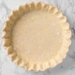 trimmed and crimped all butter pie crust in a pie plate