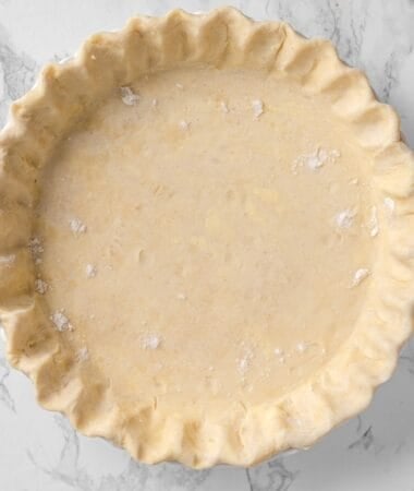 trimmed and crimped all butter pie crust in a pie plate