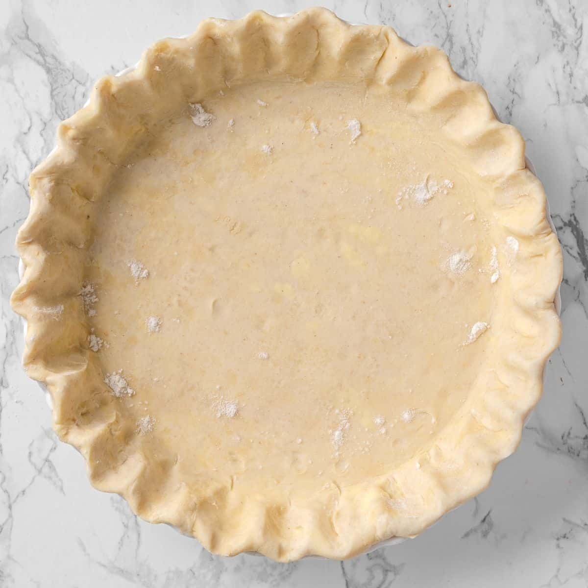 trimmed and crimped all butter pie crust in a pie plate