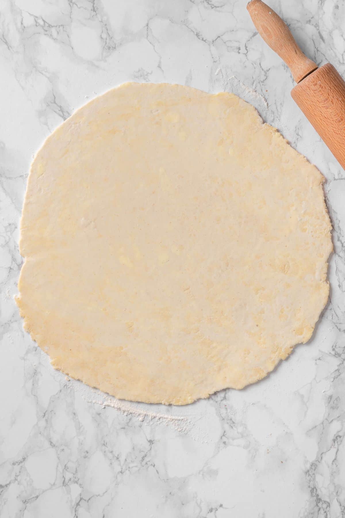cold all butter pie crust on a floured surface with a rolling pin