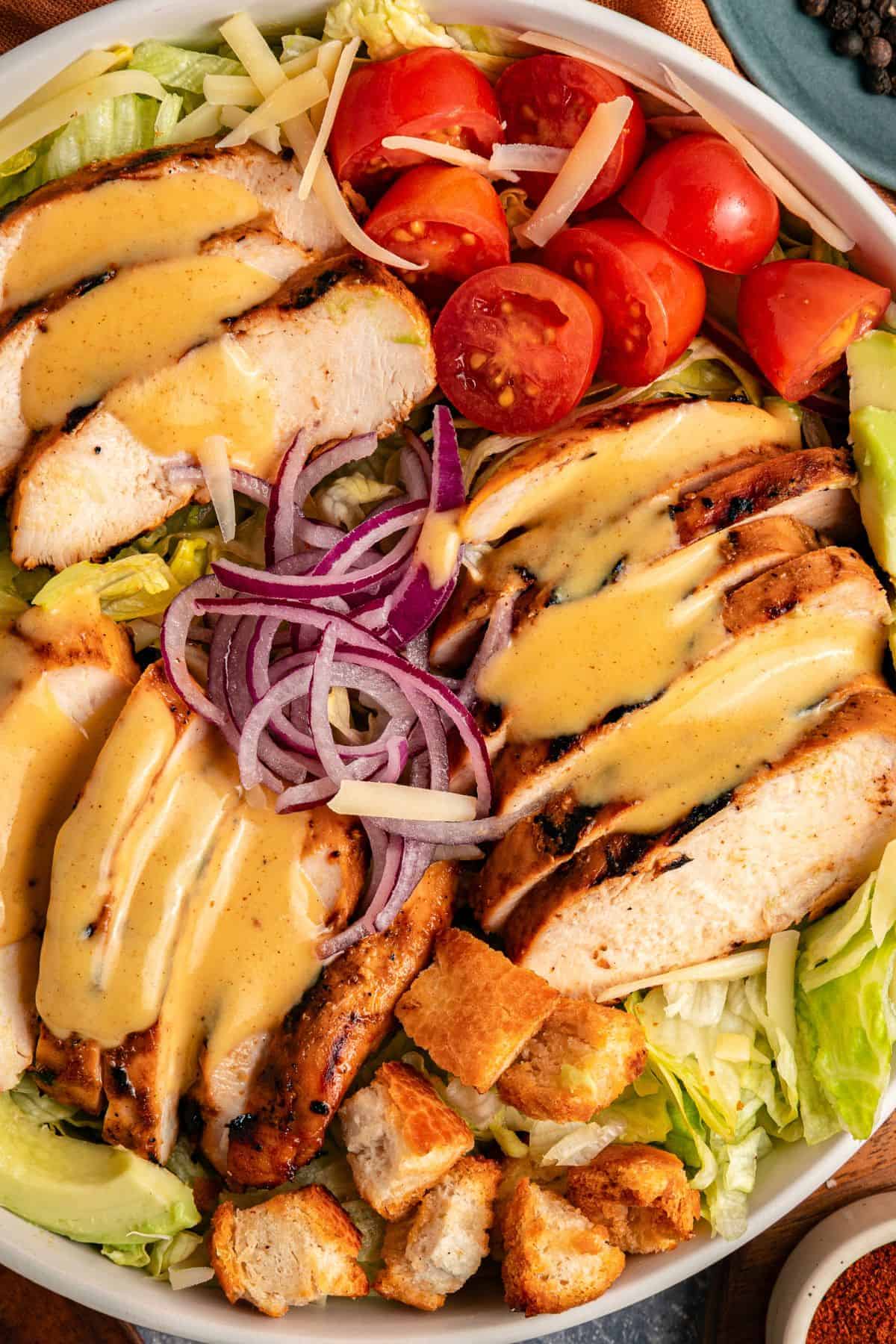 Honey mustard chicken avocado salad with fresh mixed greens