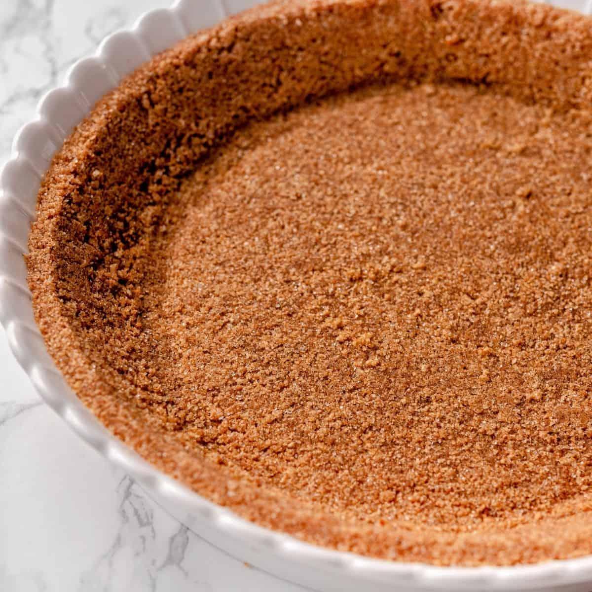 Graham cracker cookie crust made with melted butter and sugar