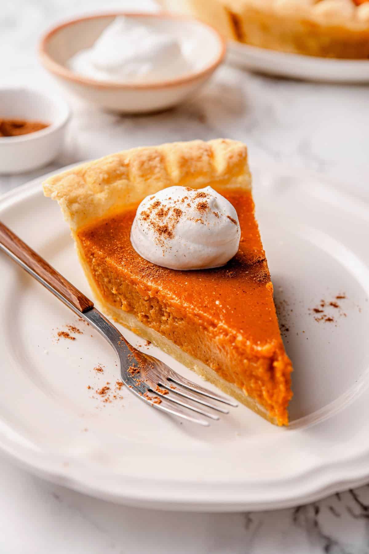 Southern sweet potato pie served with whipped cream and cinnamon