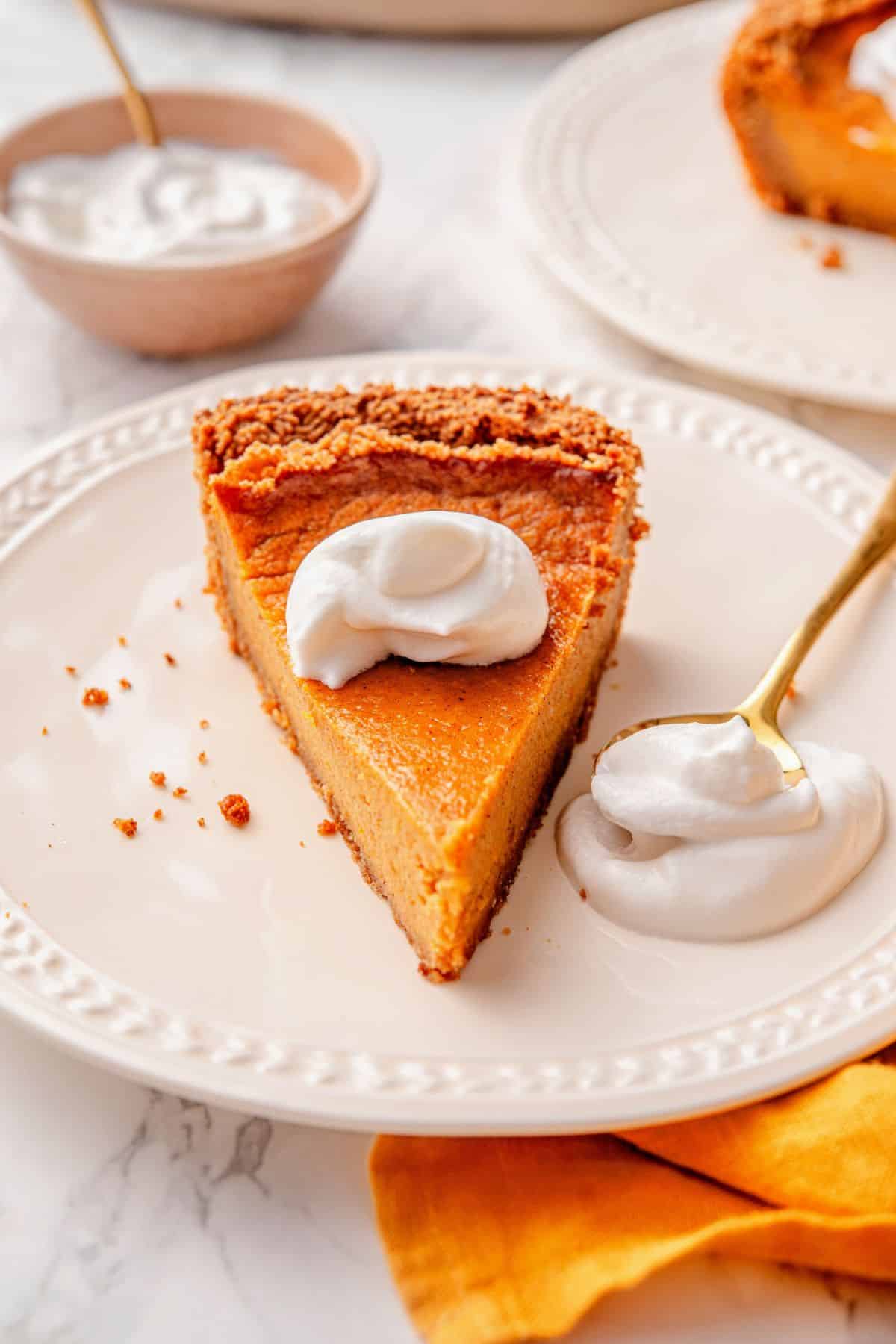 Sweet potato pie on graham cracker crust served with whipped cream