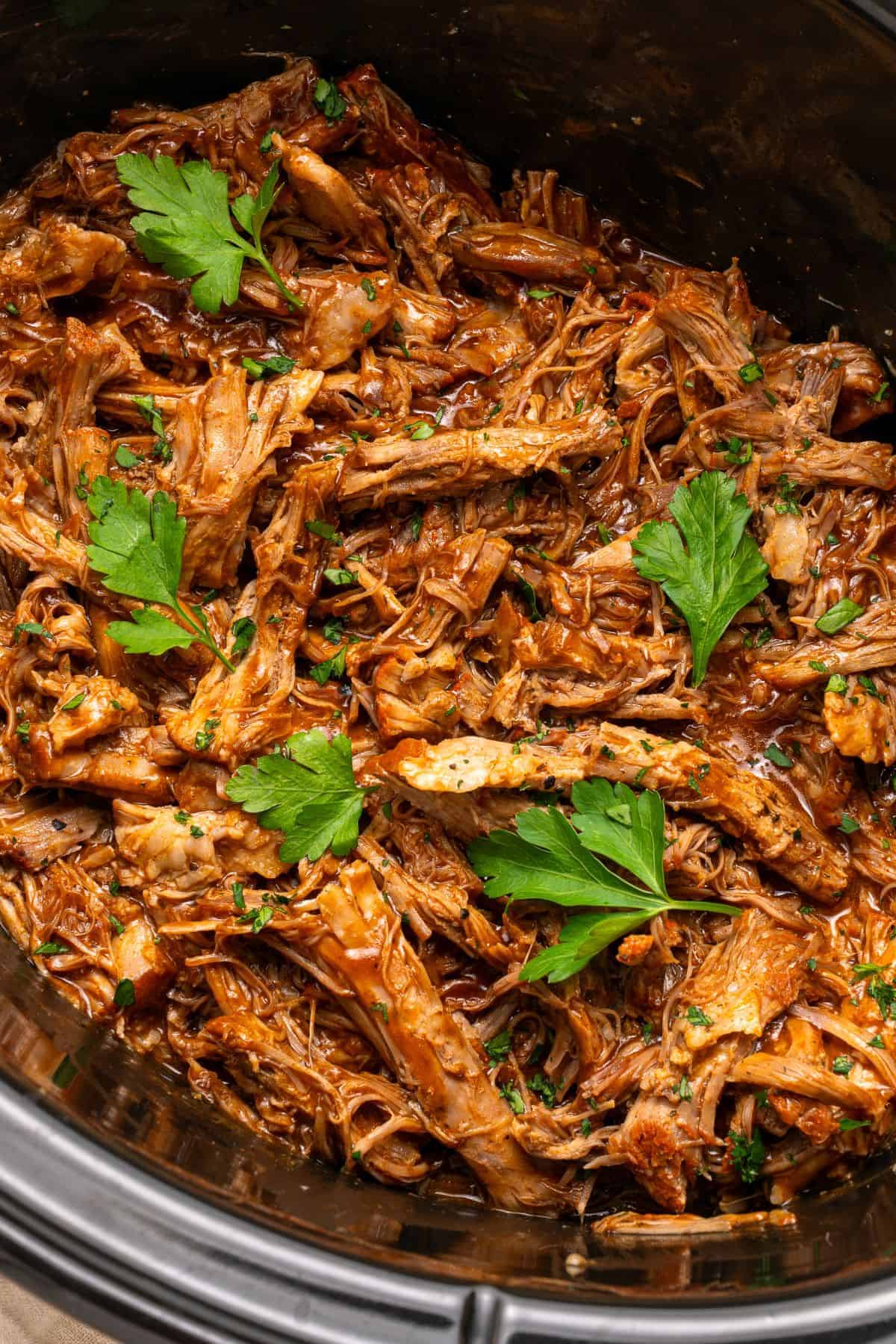 Pulled pork slow cooker with shredded pork tossed in flavorful BBQ juices