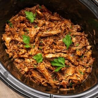 Pulled pork slow cooker recipe with juicy shredded pork and tangy BBQ sauce