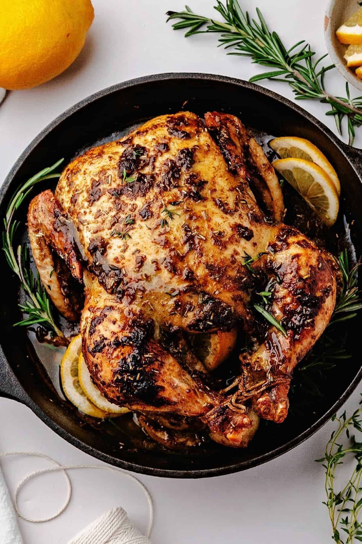 Whole roasted chicken served warm with roasted lemon and pan juices