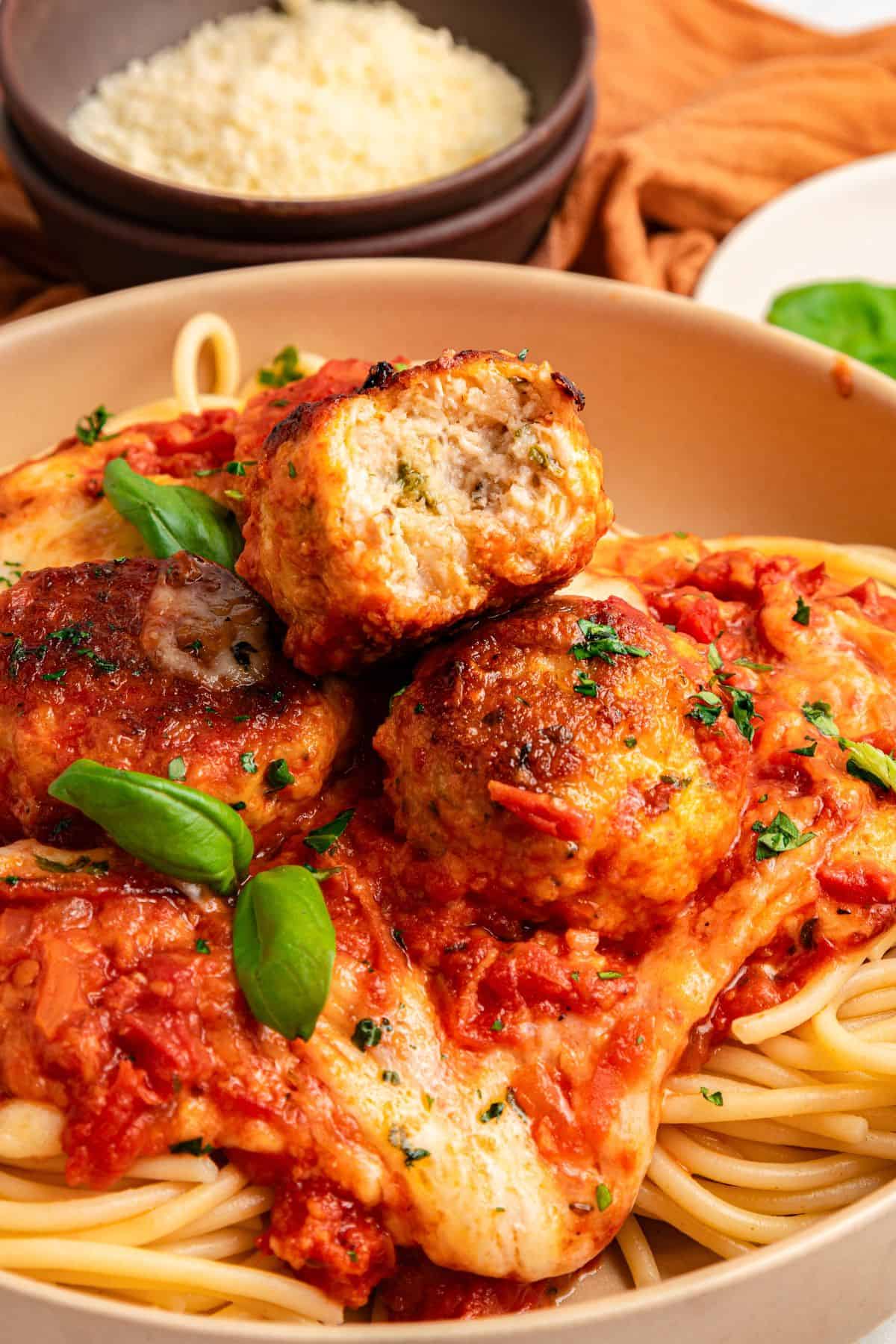Skillet chicken parmesan meatballs with golden brown chicken meatballs and melted cheese