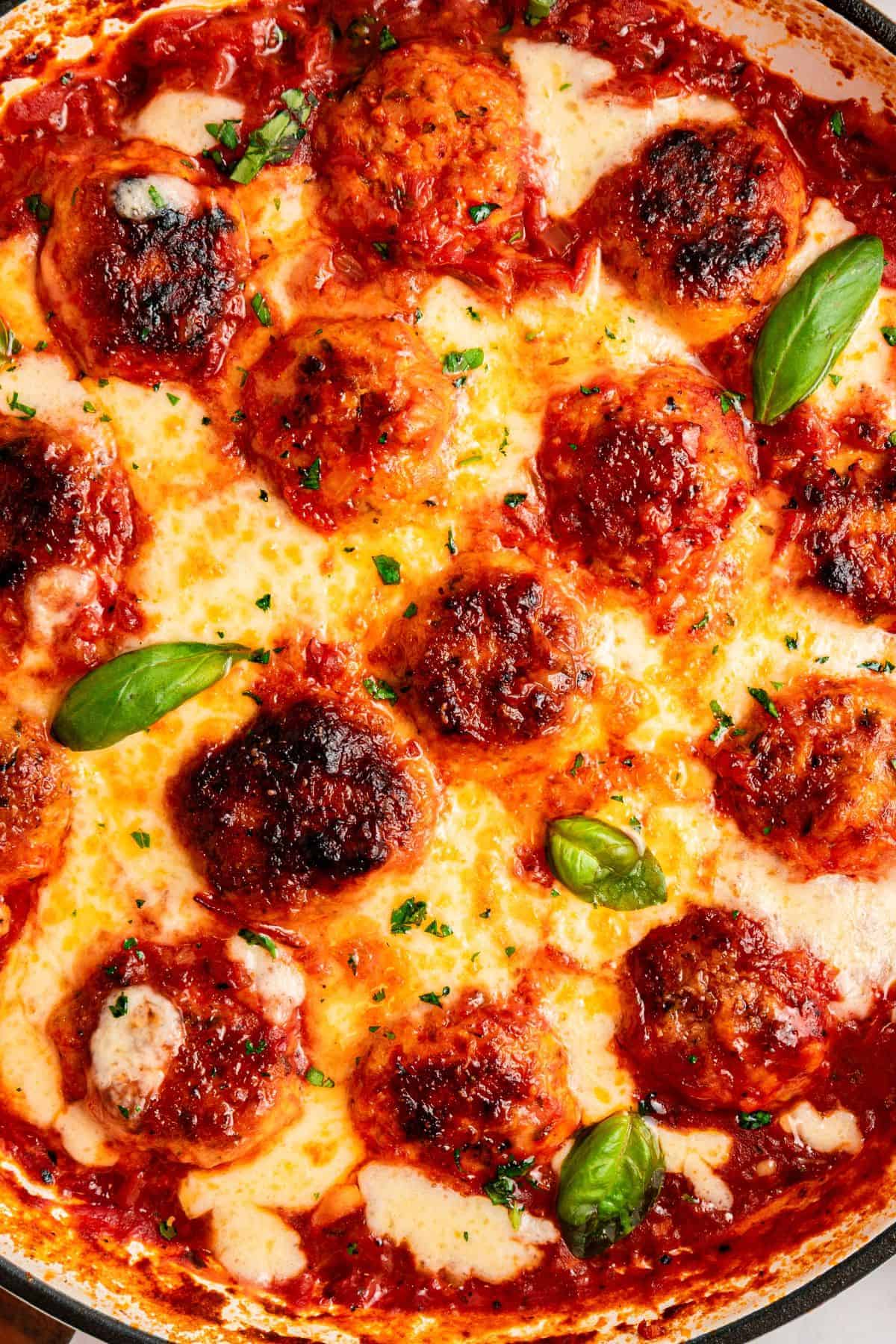Skillet chicken parm meatballs with tender centers and golden melted cheese