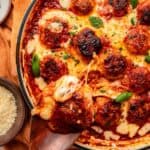 Skillet chicken parm meatballs covered with bubbling mozzarella and Parmesan