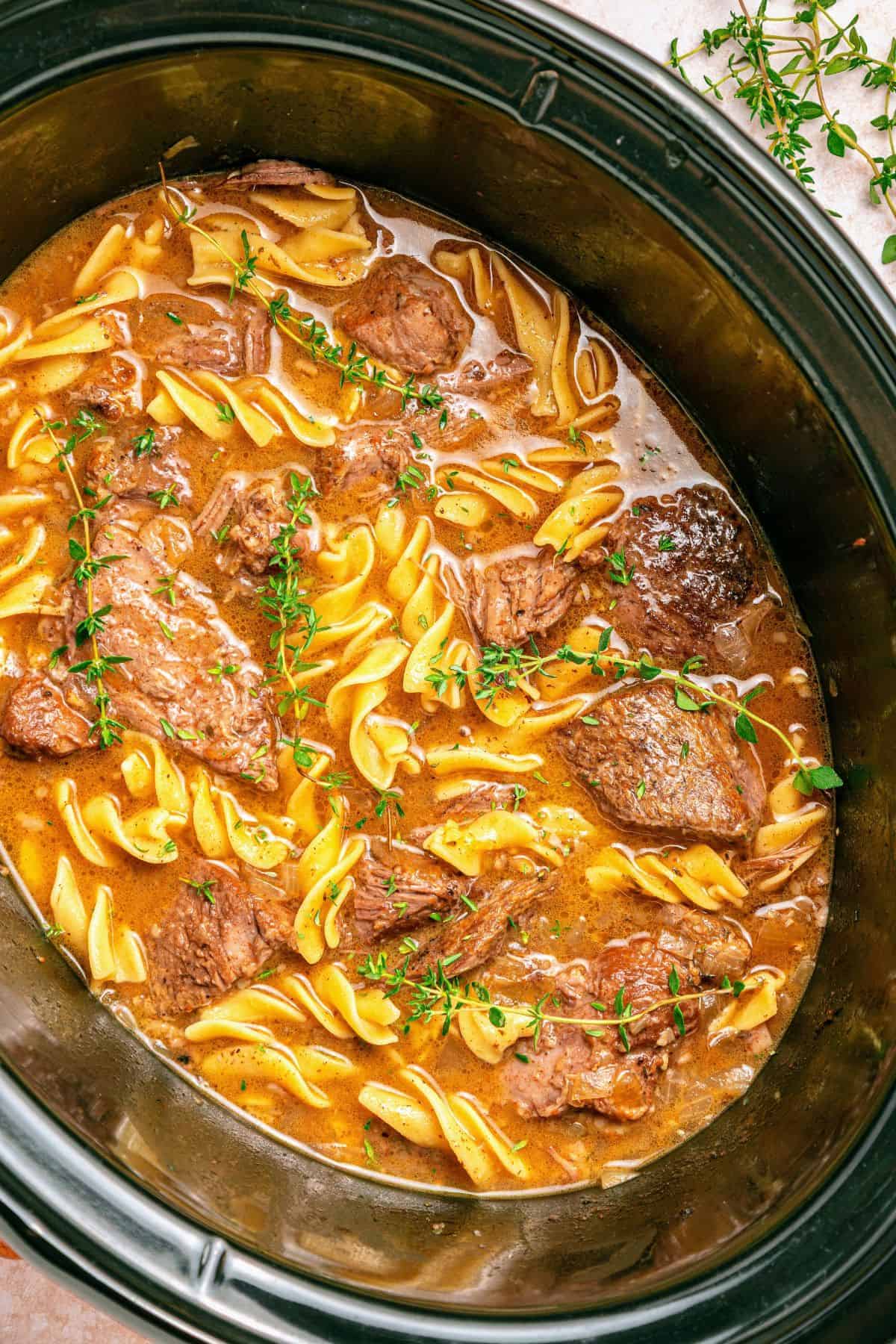 Beef and noodles crockpot recipe with tender chuck roast and rich gravy-like broth