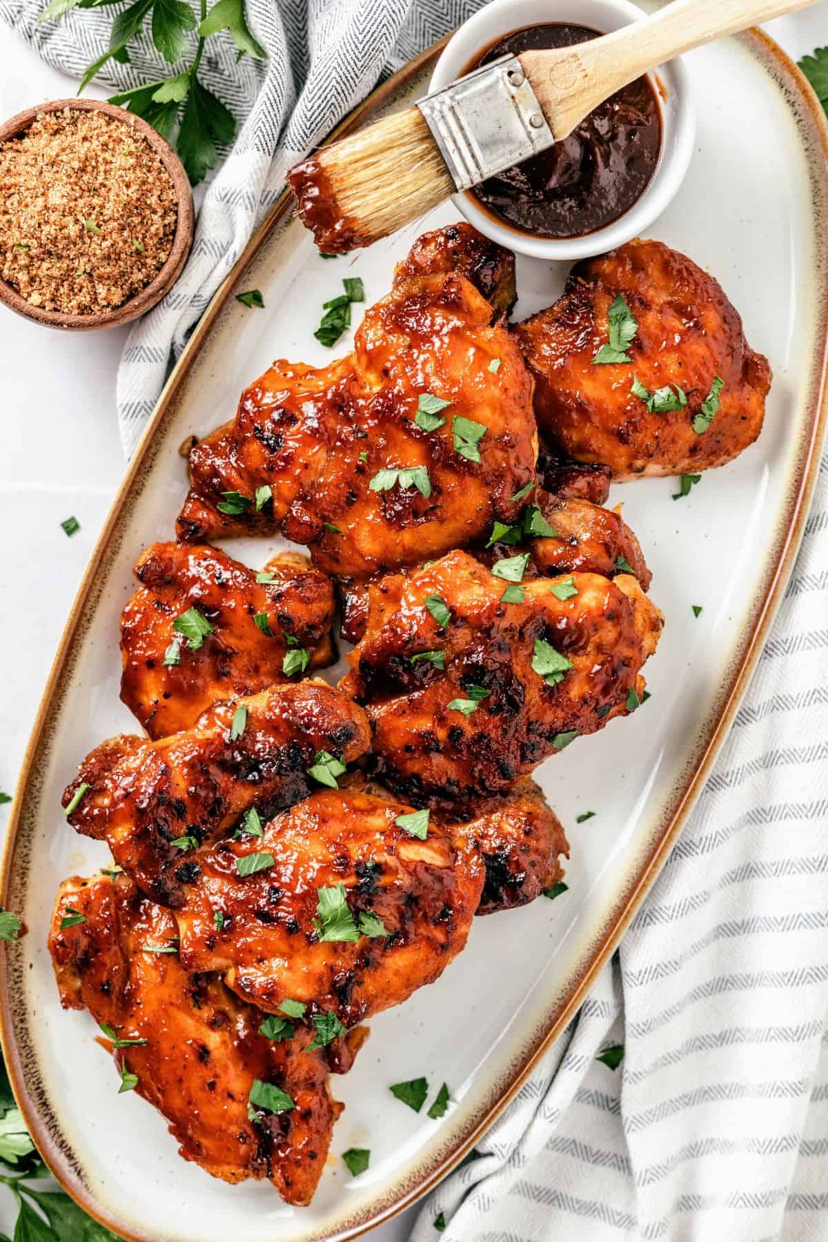 Oven baked BBQ chicken thighs with golden edges and a rich BBQ glaze