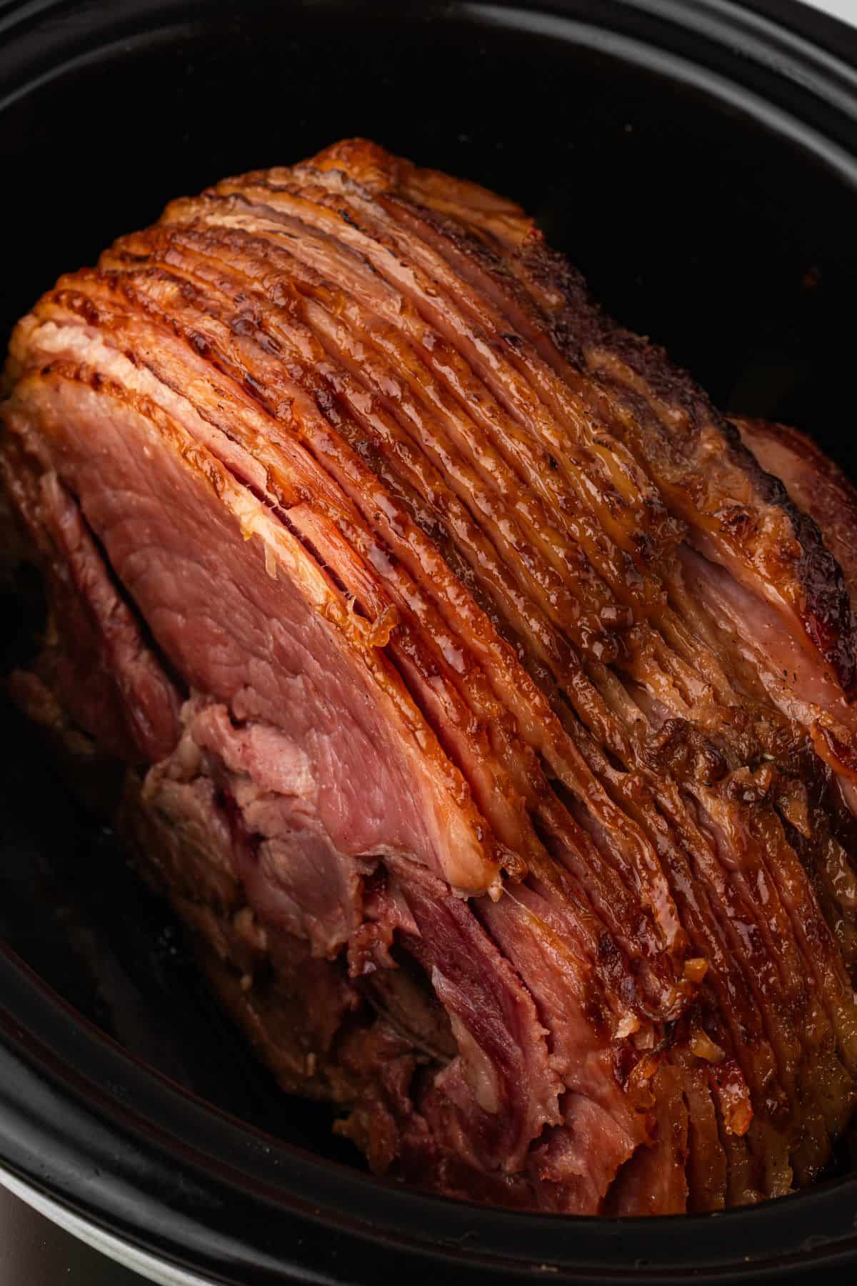 a spiral ham cooked in the crockpot with brown sugar glaze