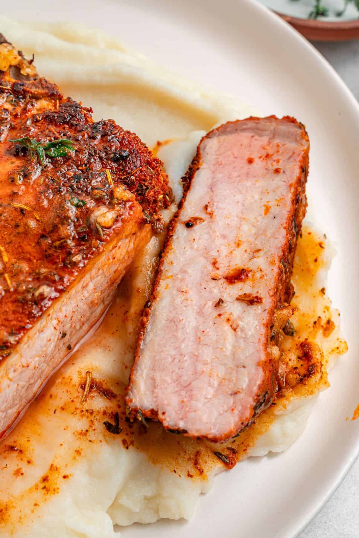Bone-in pork chop recipe made in a cast iron skillet with herb butter