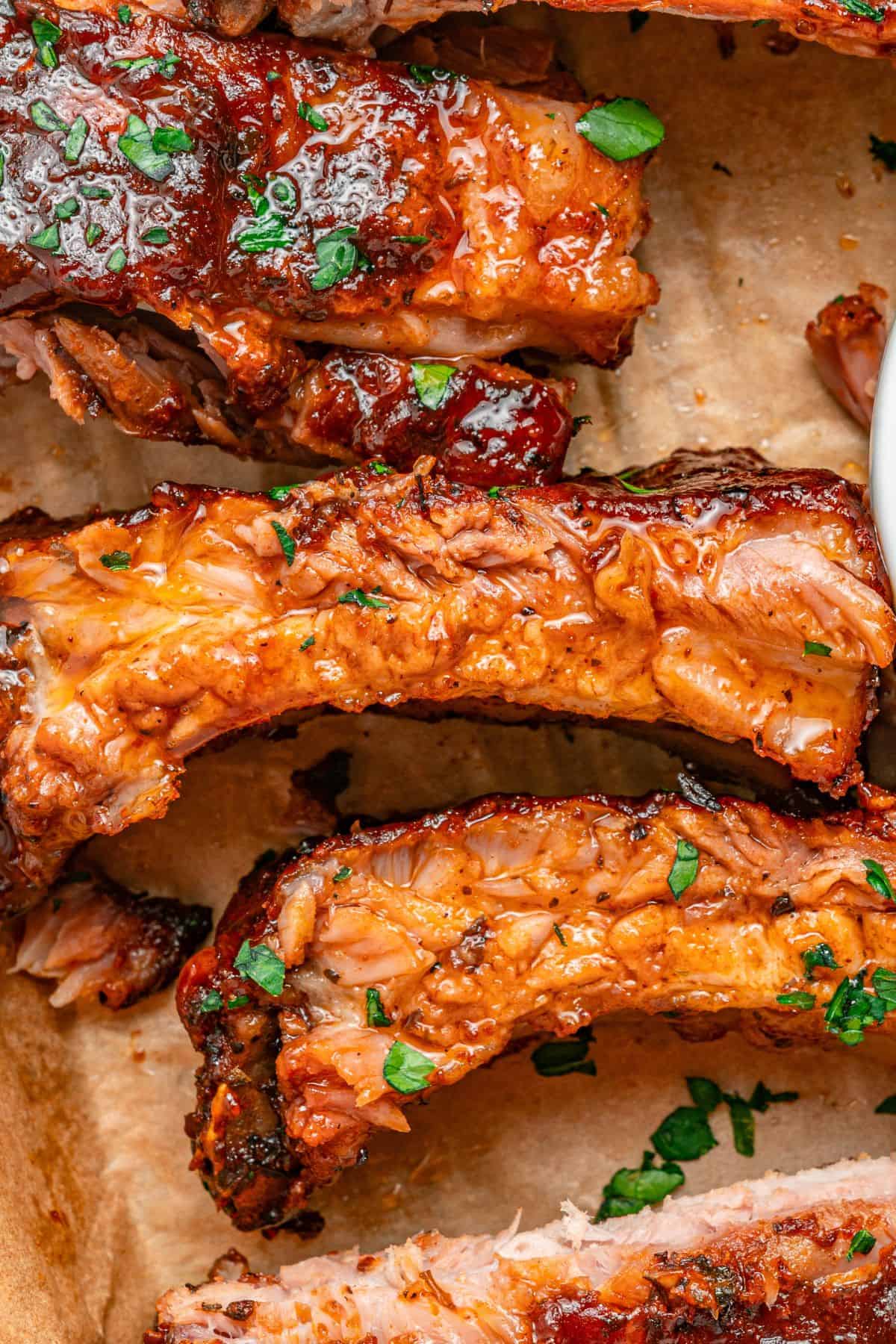 Oven-baked baby back ribs coated in sticky caramelized BBQ sauce
