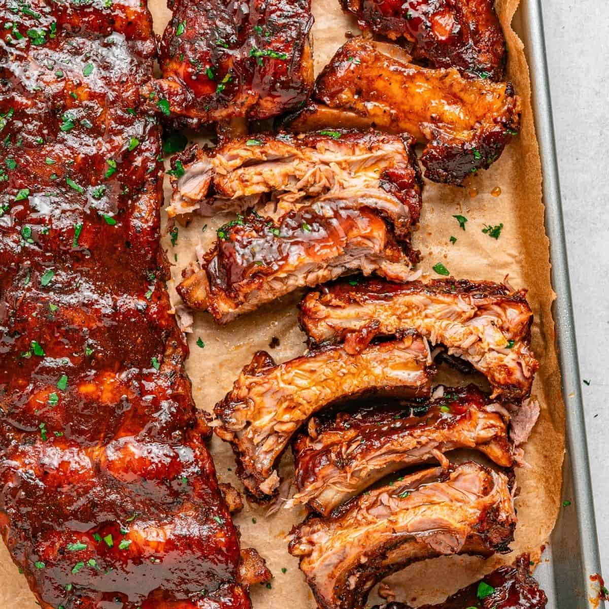Oven baked pork ribs with a flavorful dry rub and glossy BBQ glaze