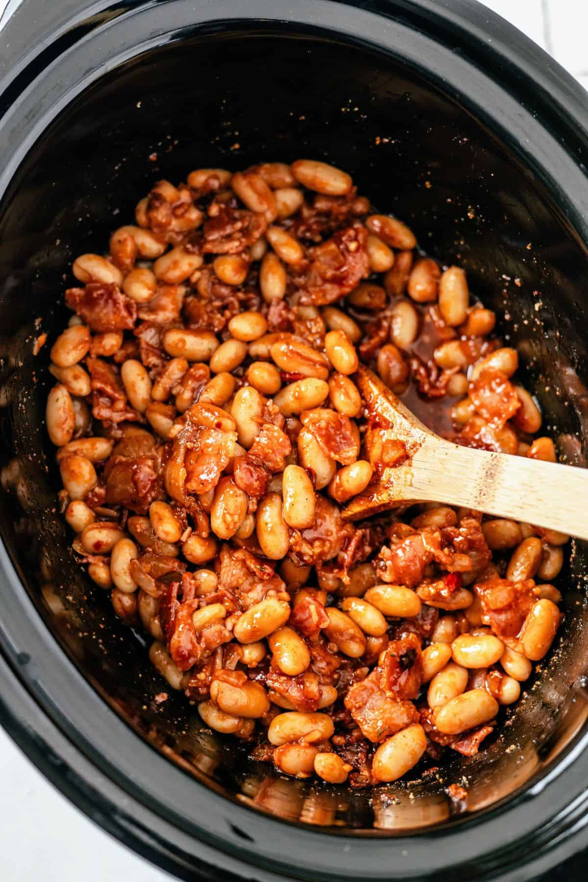 Crockpot baked beans with bacon and a thick, saucy BBQ glaze