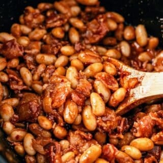 Crock pot baked beans with bacon simmered until thick and flavorful
