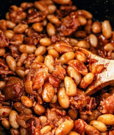 Crock pot baked beans with bacon simmered until thick and flavorful