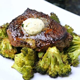 ranch seasoned steak cooked on a plate with melty garlic compound butter