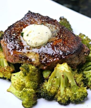 ranch seasoned steak cooked on a plate with melty garlic compound butter