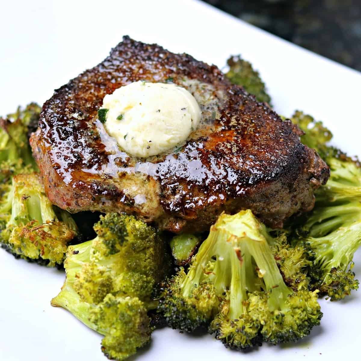 ranch seasoned steak cooked on a plate with melty garlic compound butter