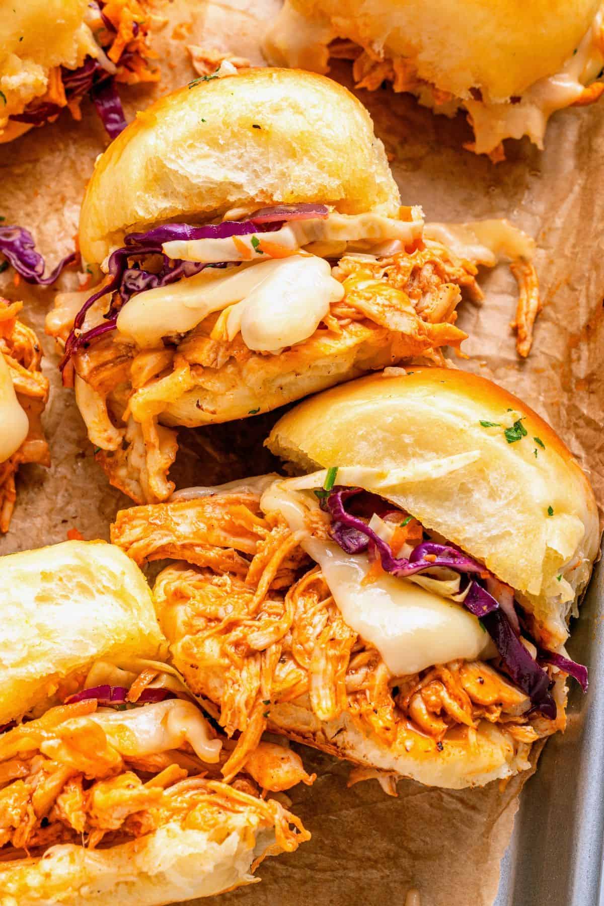Shredded chicken buffalo chicken sliders with spicy Buffalo sauce and melted cheese