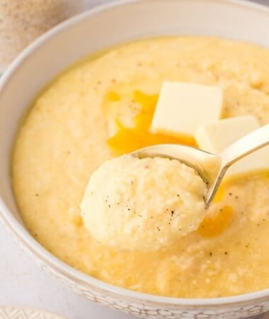 Cheesy grits recipe with a thick, smooth consistency and a rich blend of milk, cream, and cheddar