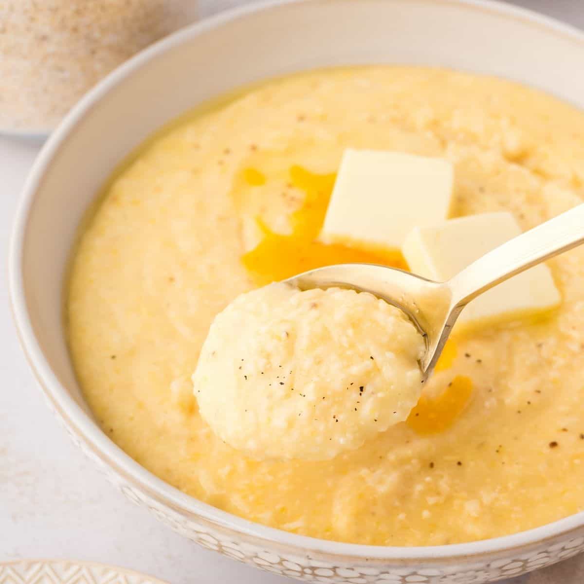 Cheesy grits recipe with a thick, smooth consistency and a rich blend of milk, cream, and cheddar