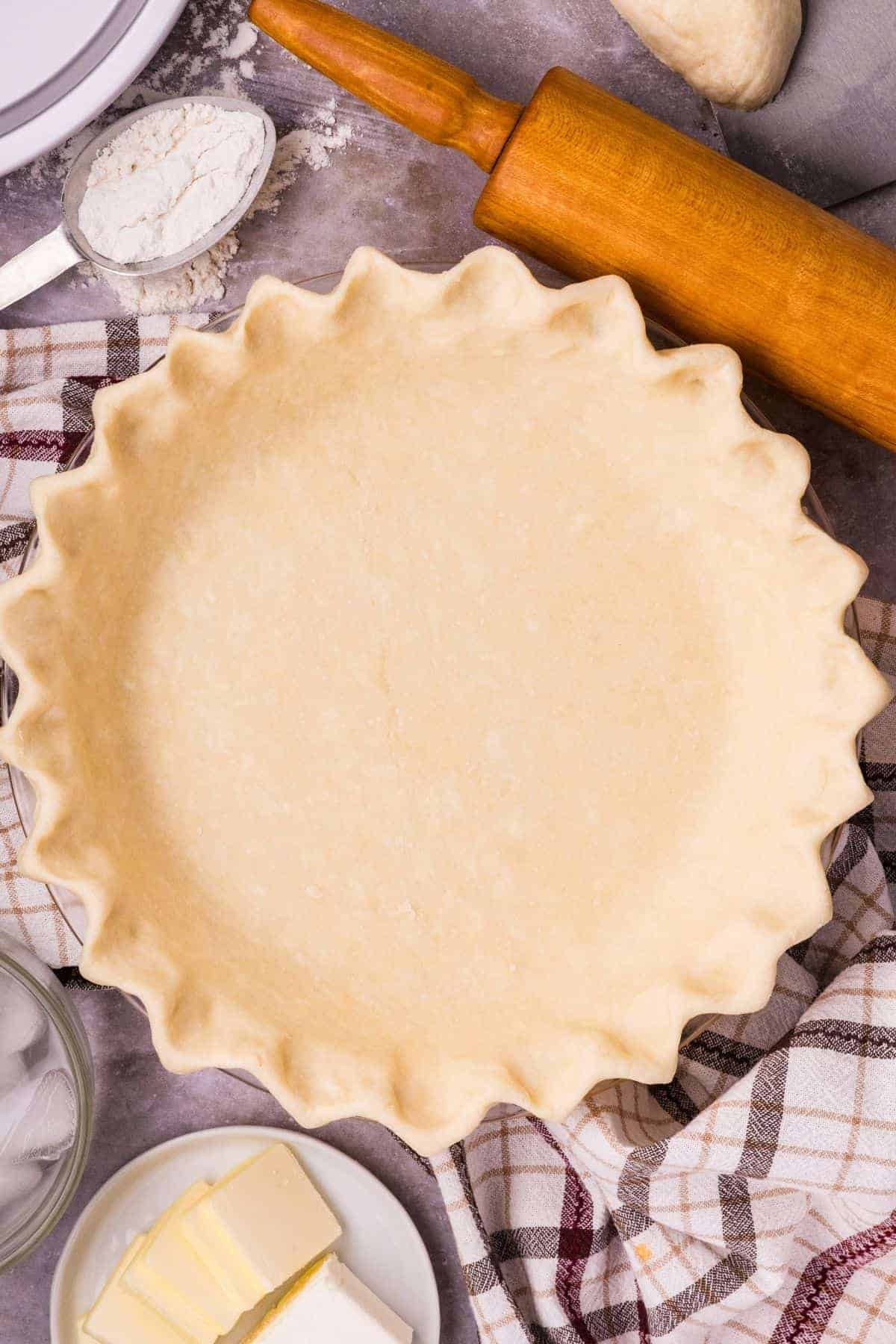 Butter cream cheese pie crust pressed into a pie plate before baking