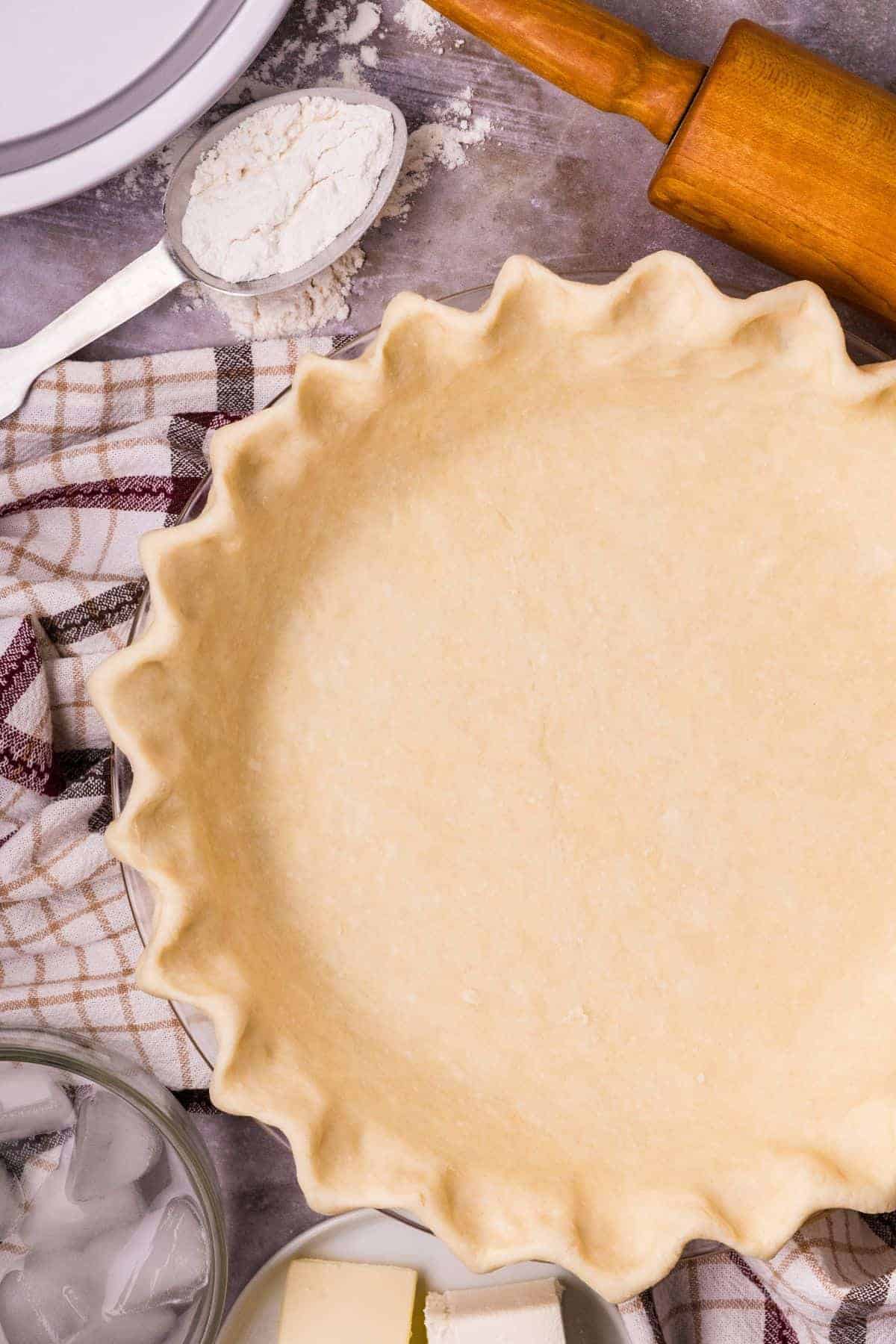 Butter cream cheese pie crust pressed into a pie plate before baking