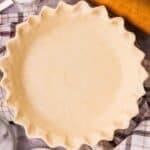 Pie crust cream cheese dough shaped into a round disk before chilling