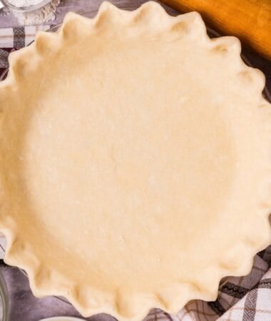 Pie crust cream cheese dough shaped into a round disk before chilling