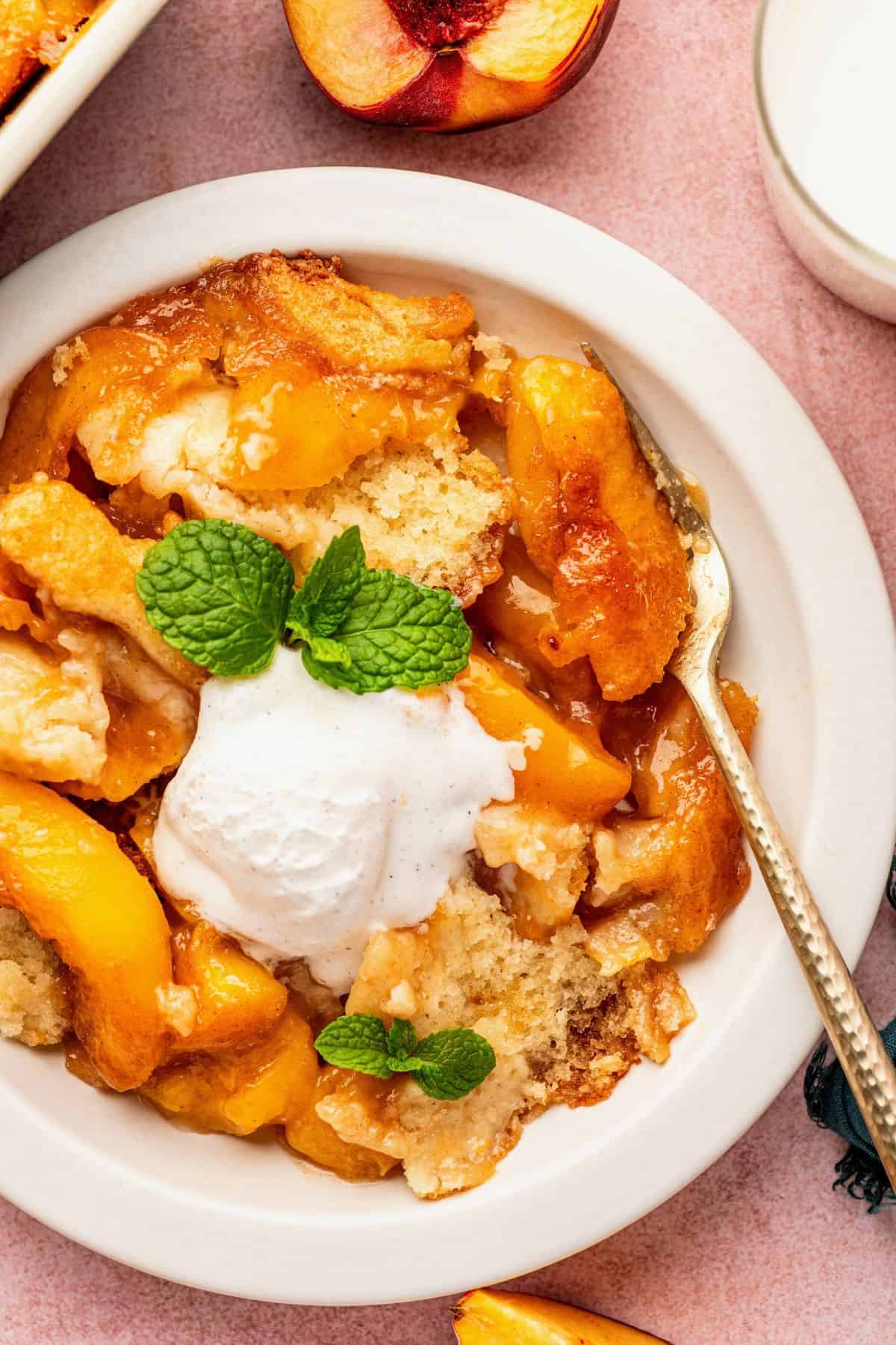Peach cobbler featuring cinnamon-spiced fruit and crisp golden edges.