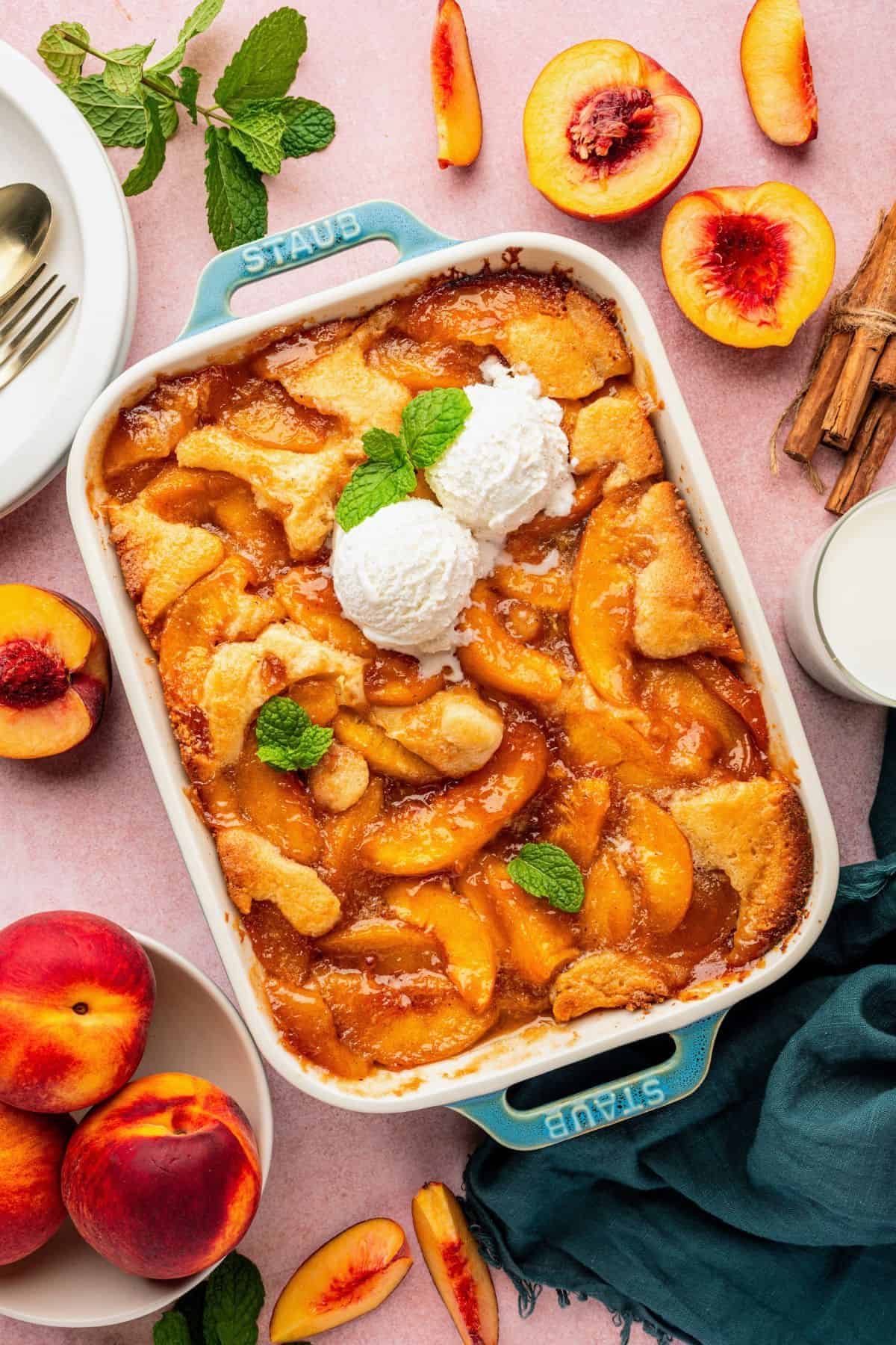 Peach cobbler with tender baked peaches covered in golden, cake-like batter.