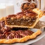 Classic pecan pie served in a pie dish with a golden pecan topping and rich filling