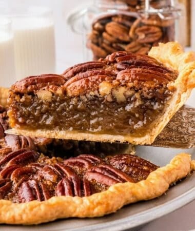 Classic pecan pie served in a pie dish with a golden pecan topping and rich filling