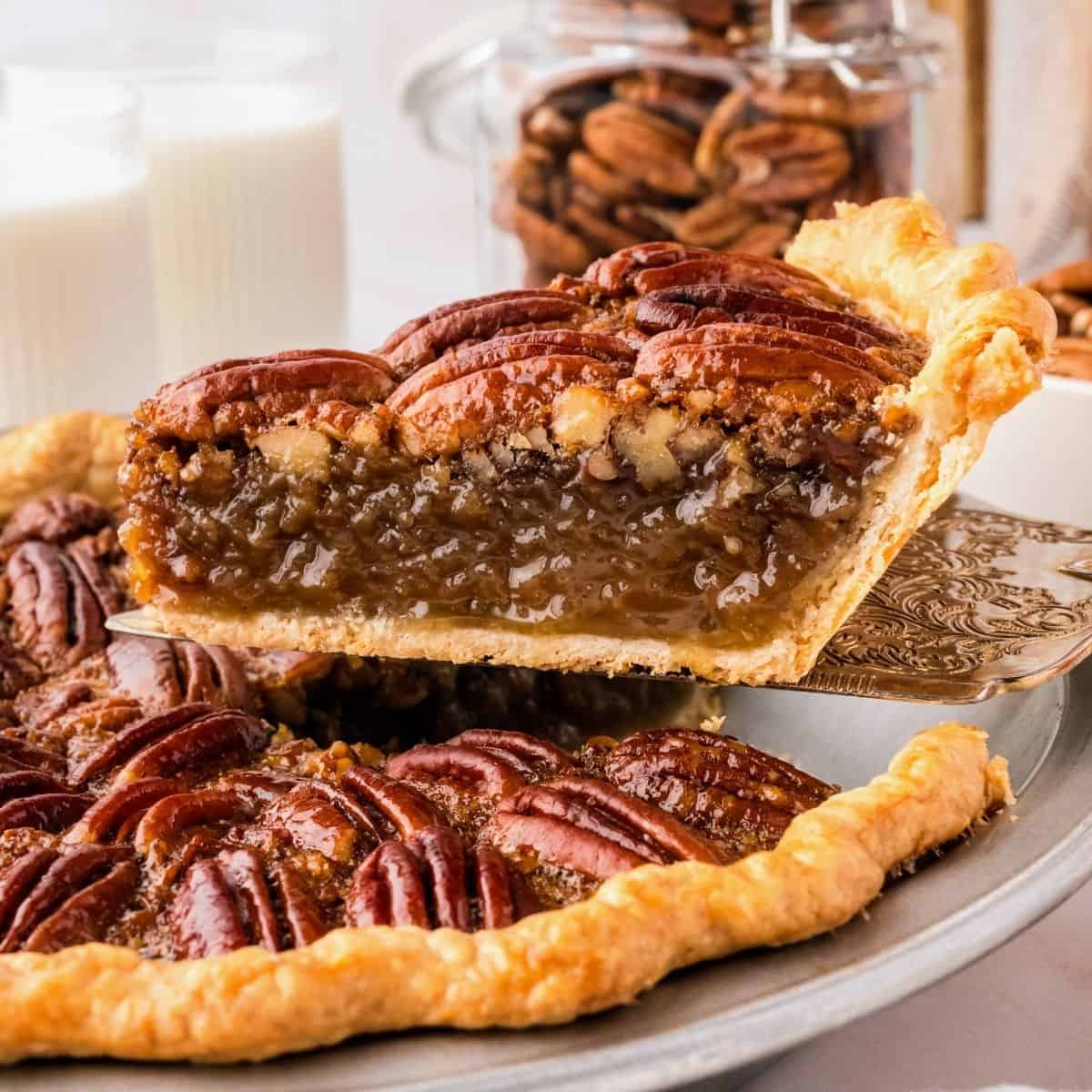 Classic pecan pie served in a pie dish with a golden pecan topping and rich filling