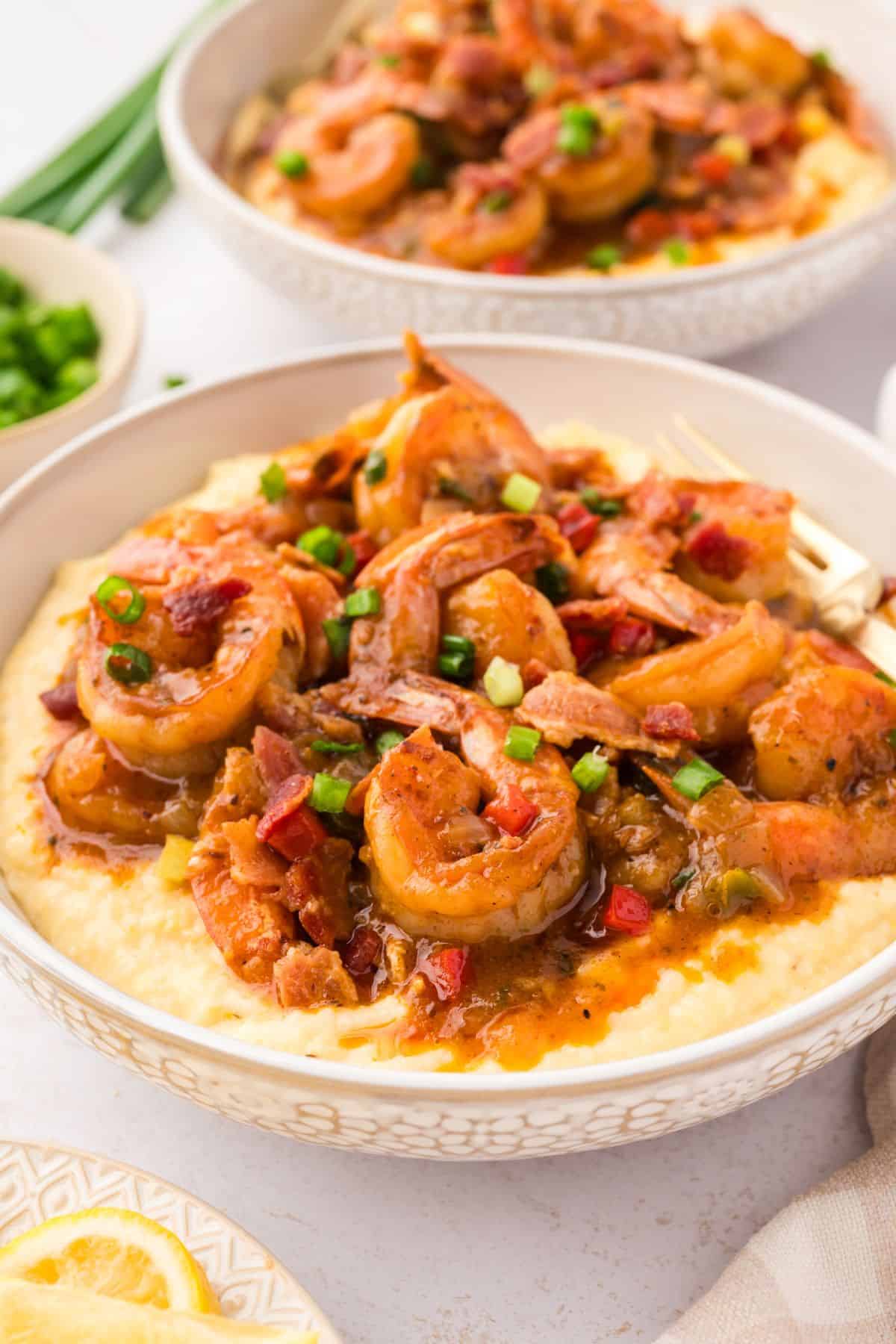 Creamy shrimp and grits topped with juicy shrimp, crispy bacon, and savory sautéed vegetables