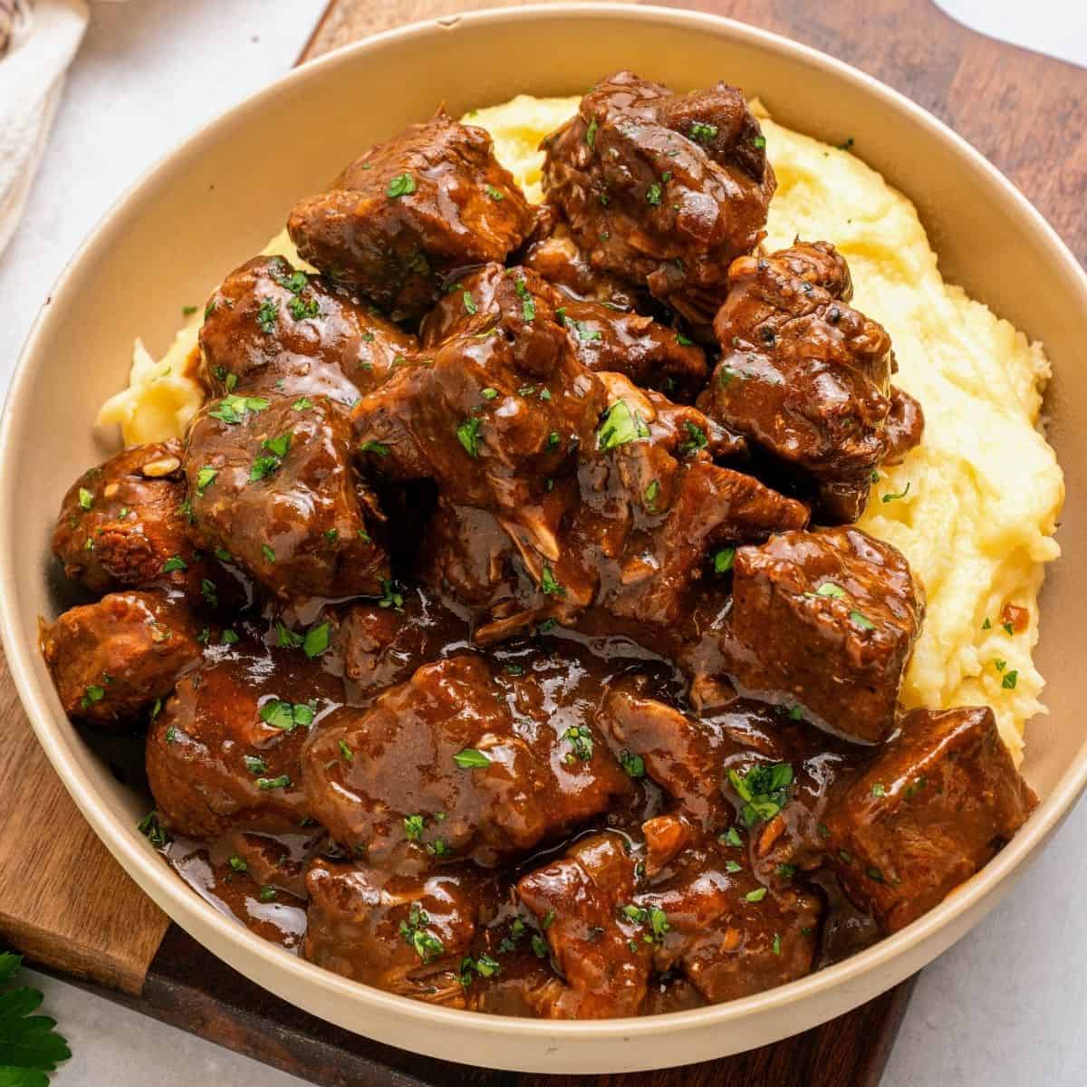 Slow cooked beef tips and gravy served with mashed potatoes and savory brown sauce