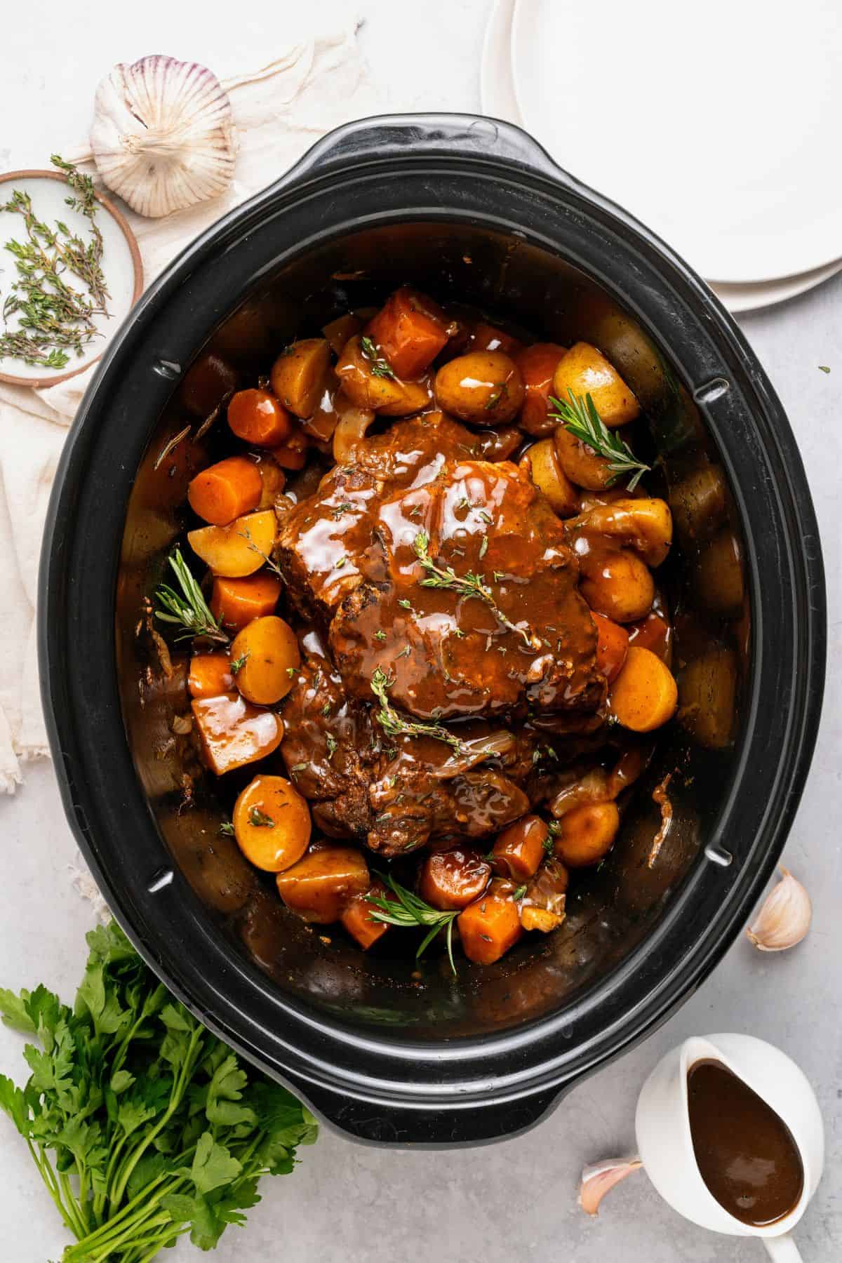 Pot roast in slow cooker with fork-tender meat and a homemade gravy made from the cooking juices